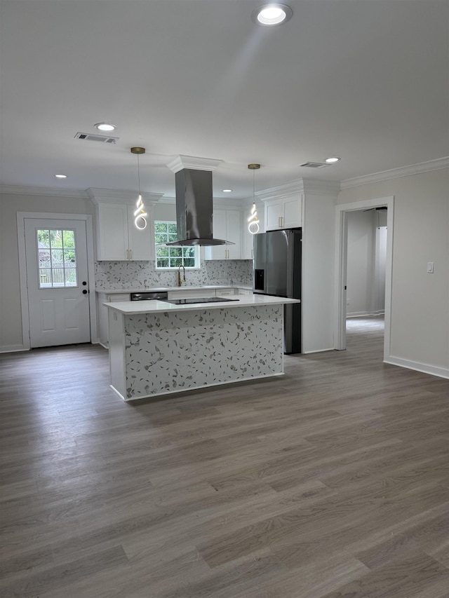 3824 Hays Ave, Groves, TX 77619 - kitchen with island exhaust hood, stainless steel fridge with ice dispenser, crown molding, light countertops, and white cabinetry