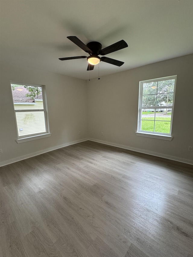 3824 Hays Ave, Groves, TX 77619 - unfurnished room with plenty of natural light, wood finished floors, and ceiling fan
