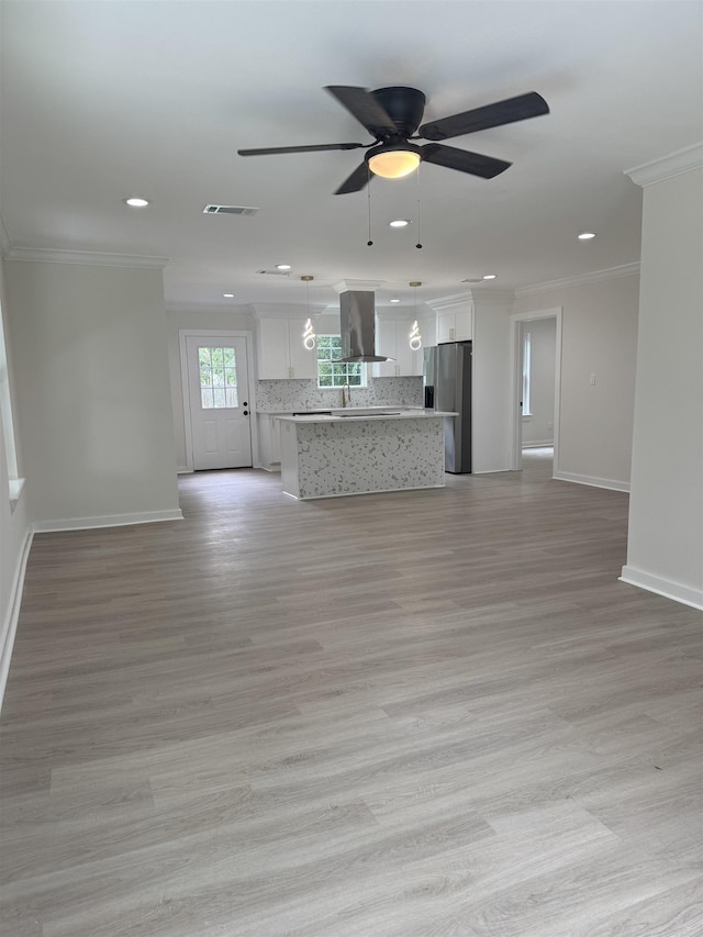 3824 Hays Ave, Groves, TX 77619 - unfurnished living room featuring ornamental molding, recessed lighting, ceiling fan, and light wood-style flooring