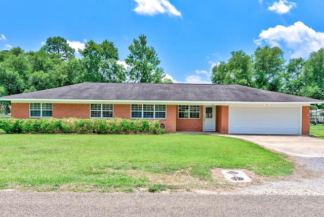 ranch-style house featuring a garage and a front lawn