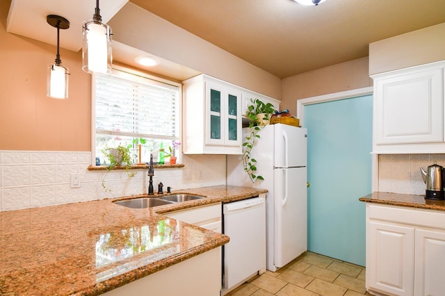 740 Randolph Cir, Beaumont, TX 77706 - kitchen with white appliances, a sink, decorative backsplash, light stone countertops, and white cabinets