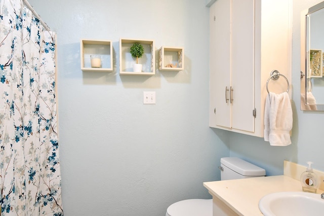 740 Randolph Cir, Beaumont, TX 77706 - bathroom with toilet, vanity, and a shower with shower curtain