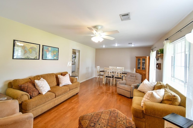 740 Randolph Cir, Beaumont, TX 77706 - living room featuring light wood-style floors, ceiling fan, and baseboards