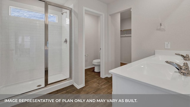 bathroom featuring walk in shower, toilet, vanity, and hardwood / wood-style flooring