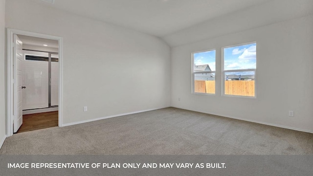 carpeted empty room featuring vaulted ceiling