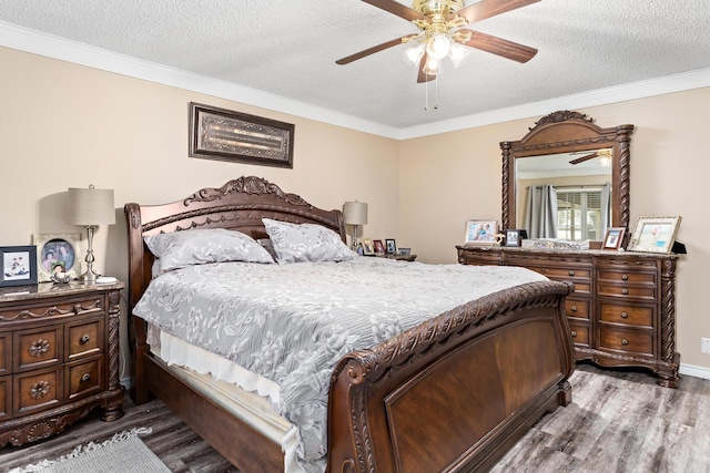 bedroom with ornamental molding, a textured ceiling, and wood finished floors