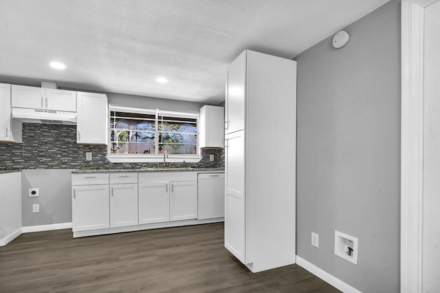 kitchen featuring dark wood finished floors, white dishwasher, white cabinets, and a sink