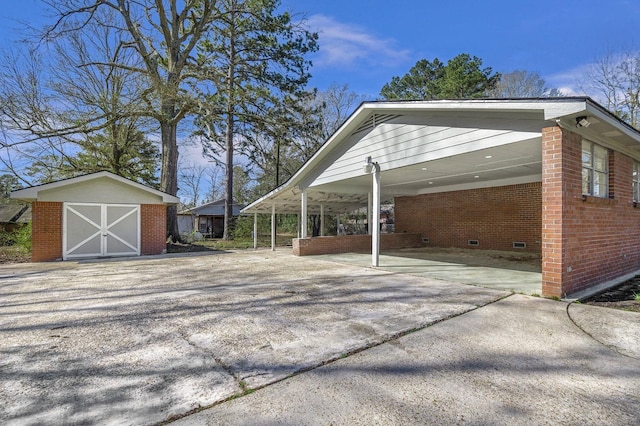 exterior space with a storage shed and concrete driveway