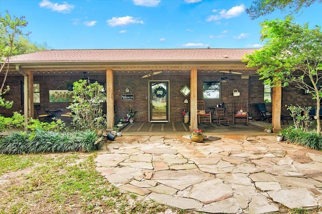 2999 59th St, Port Arthur, TX 77640 - rear view of house featuring brick siding and a porch