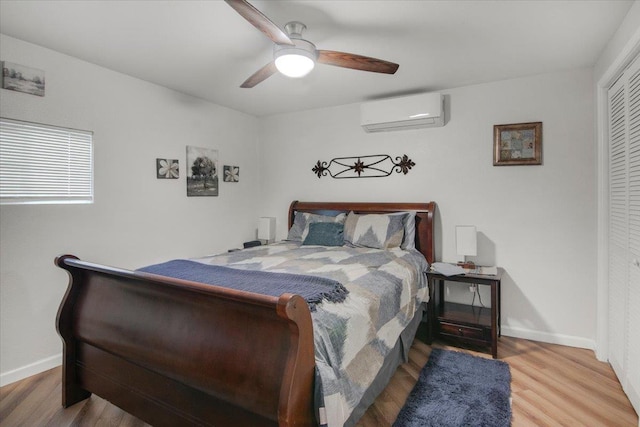 2999 59th St, Port Arthur, TX 77640 - bedroom with a wall unit AC, wood finished floors, a closet, and baseboards