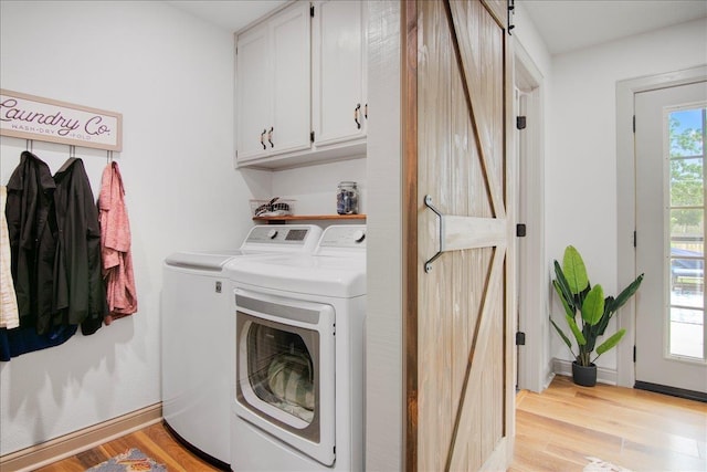 2999 59th St, Port Arthur, TX 77640 - laundry room featuring washer and clothes dryer, cabinet space, light wood-style floors, and baseboards