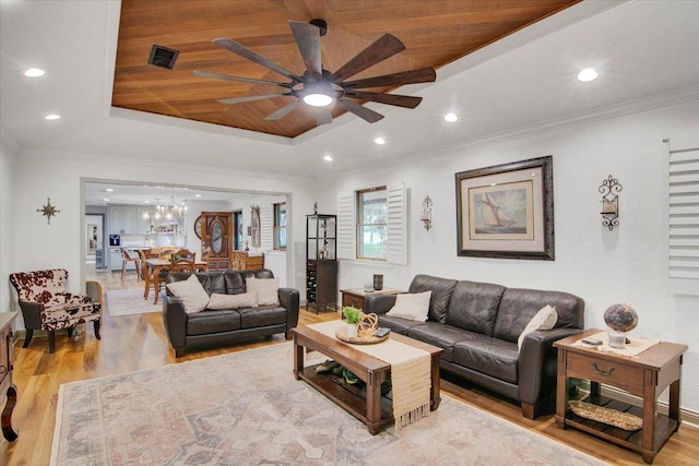 2999 59th St, Port Arthur, TX 77640 - living room featuring light wood-style flooring, a ceiling fan, a raised ceiling, a chandelier, and wooden ceiling