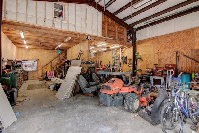 2999 59th St, Port Arthur, TX 77640 - garage with wood walls and a workshop area