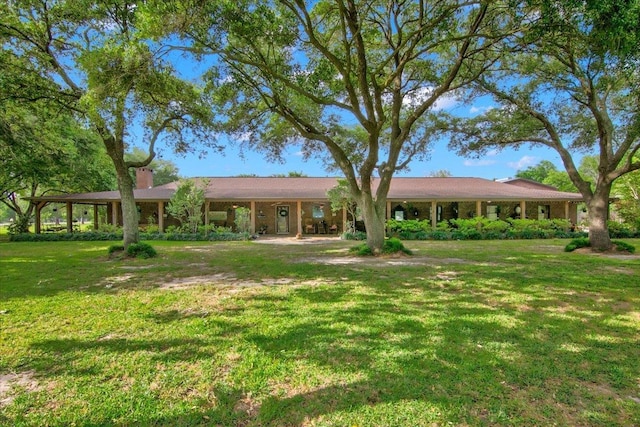 2999 59th St, Port Arthur, TX 77640 - view of front of house with a front yard and a chimney