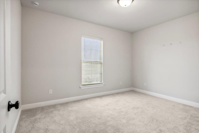 unfurnished room featuring light colored carpet