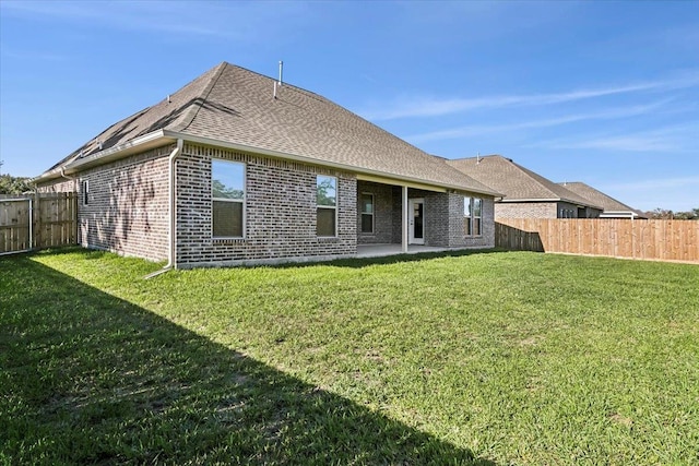 back of property featuring a yard and a patio area