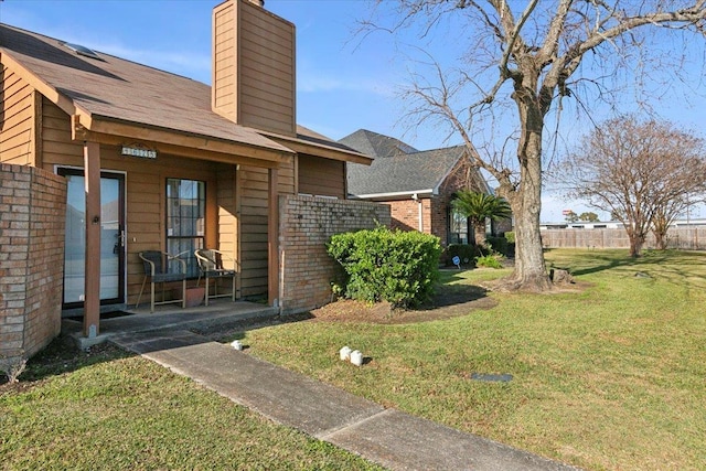 property entrance with a lawn