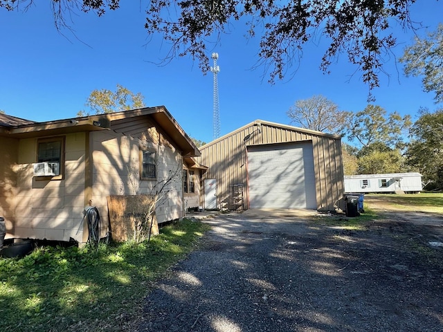 view of side of property with a garage and an outdoor structure