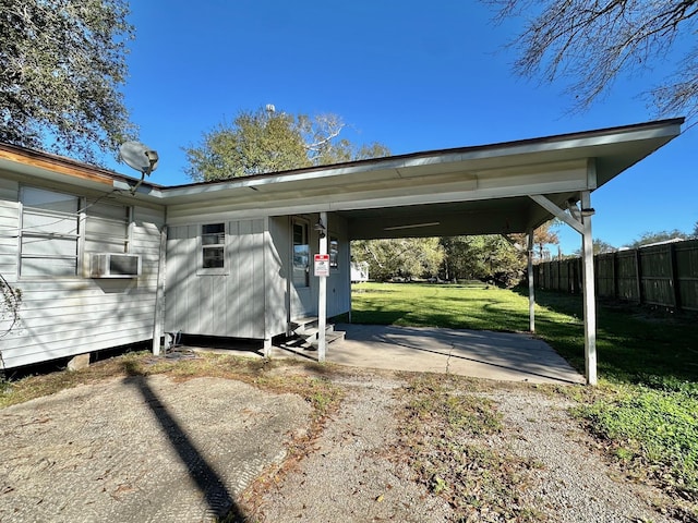 view of parking / parking lot featuring a lawn and a carport