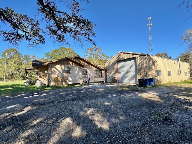 view of side of home featuring an outdoor structure and a garage