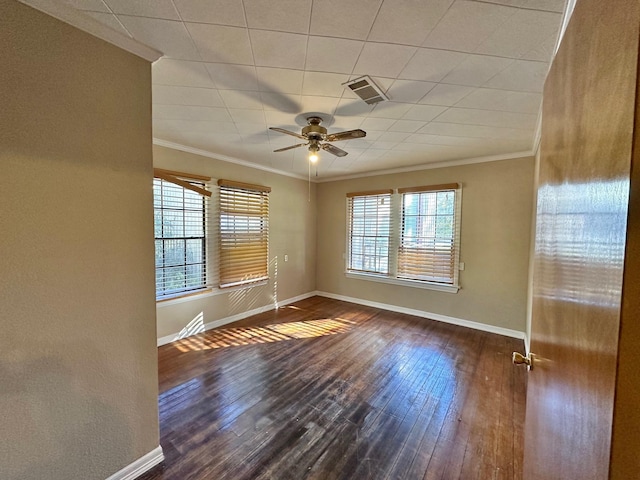 empty room featuring ceiling fan, crown molding, and dark wood-type flooring