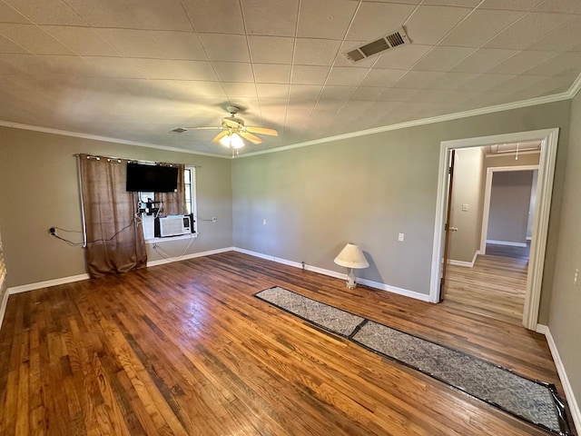 empty room with ceiling fan, hardwood / wood-style floors, cooling unit, and crown molding