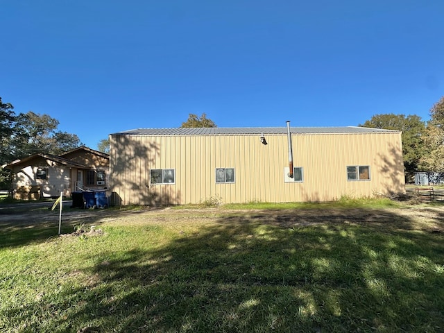 view of property exterior with a lawn