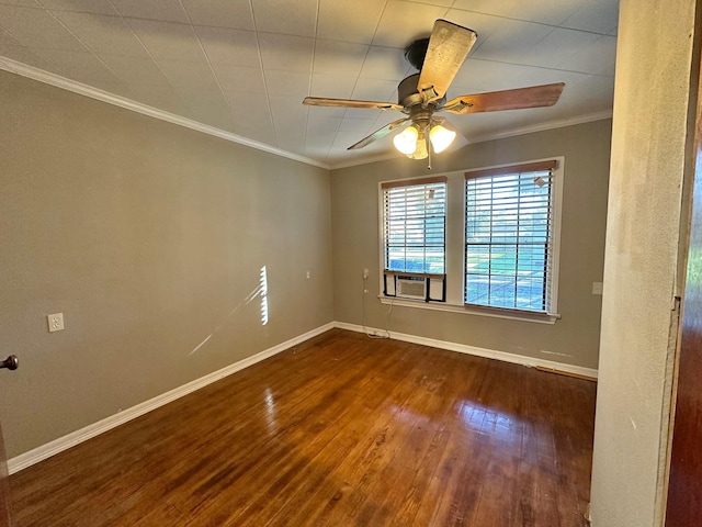 empty room with ceiling fan, dark hardwood / wood-style flooring, and ornamental molding