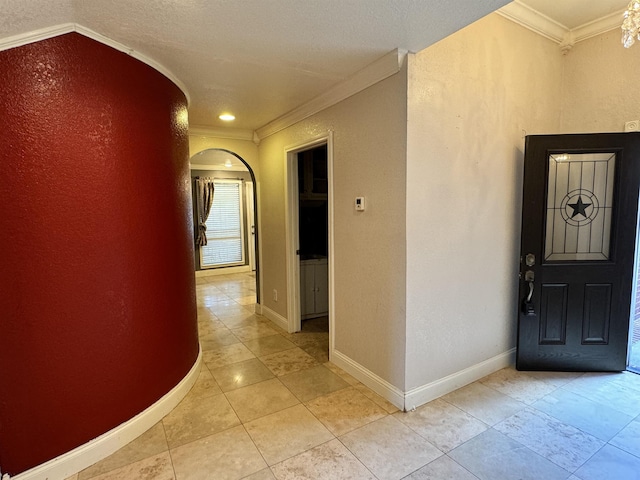 interior space featuring light tile patterned floors and ornamental molding