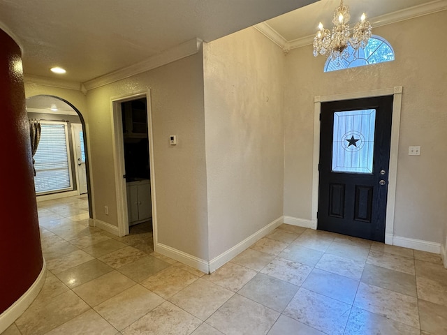 entrance foyer with an inviting chandelier and crown molding