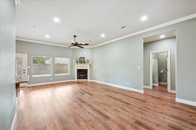 unfurnished living room featuring baseboards, a ceiling fan, and light wood-style floors