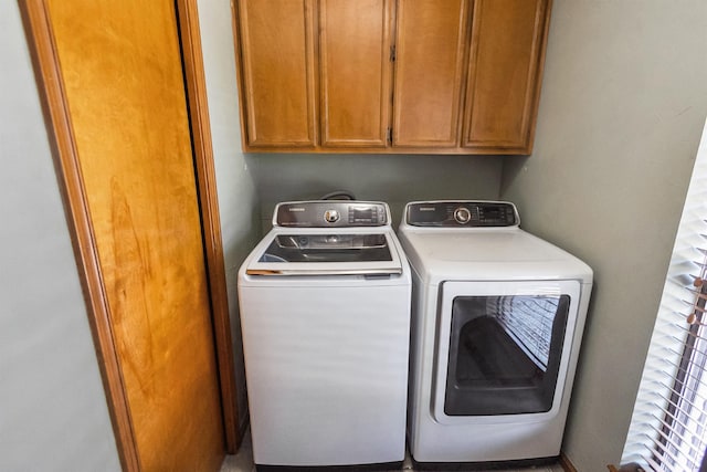 washroom with cabinet space and independent washer and dryer