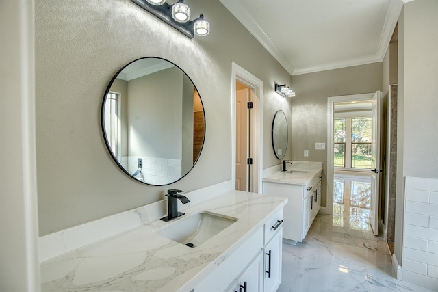 bathroom featuring marble finish floor, crown molding, and a sink