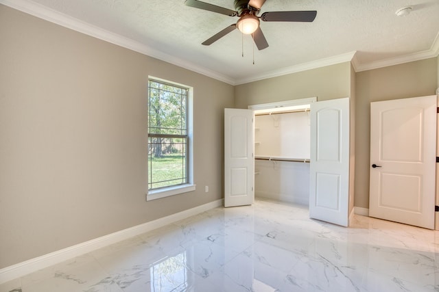 unfurnished bedroom with a textured ceiling, marble finish floor, ornamental molding, and baseboards