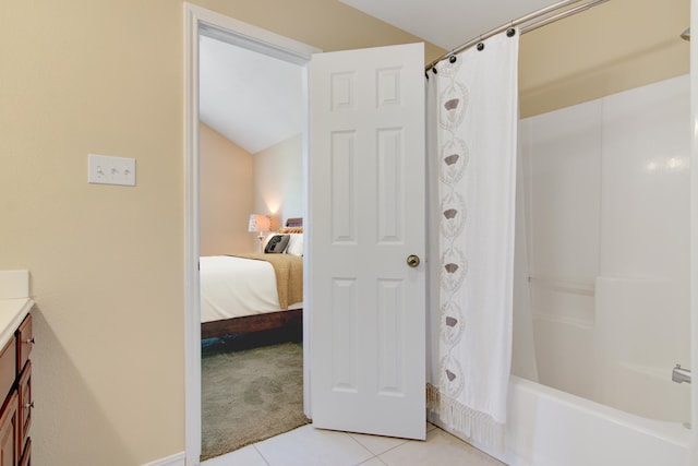 bathroom featuring shower / bath combo with shower curtain, tile patterned flooring, and vanity