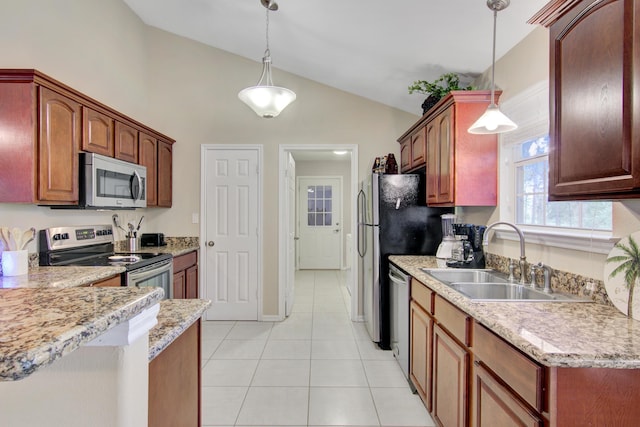 kitchen with hanging light fixtures, stainless steel appliances, lofted ceiling, light tile patterned floors, and sink