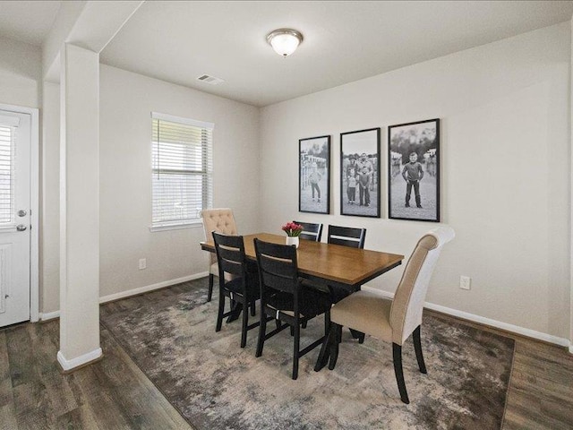 dining area with baseboards and wood finished floors