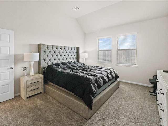 carpeted bedroom featuring baseboards, vaulted ceiling, and visible vents