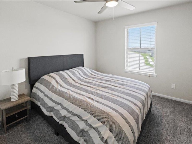 carpeted bedroom featuring baseboards and ceiling fan