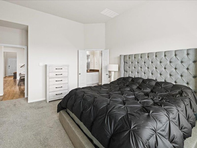 bedroom with visible vents and carpet