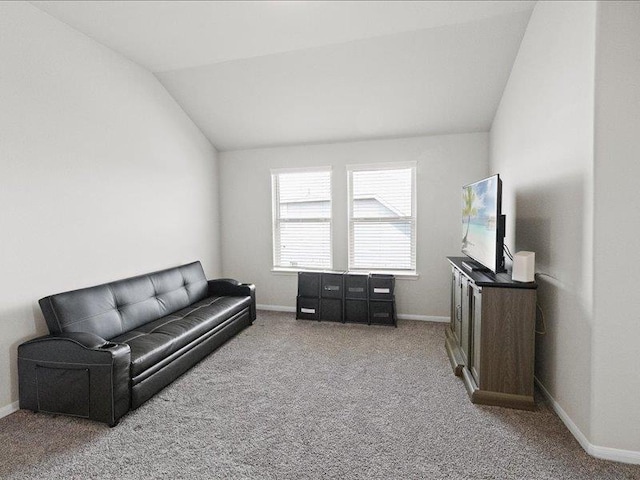 living area with baseboards, carpet, and vaulted ceiling