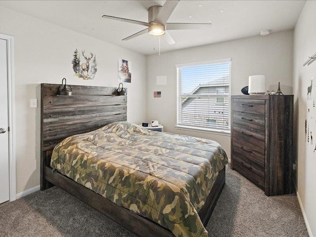 carpeted bedroom with a ceiling fan and baseboards