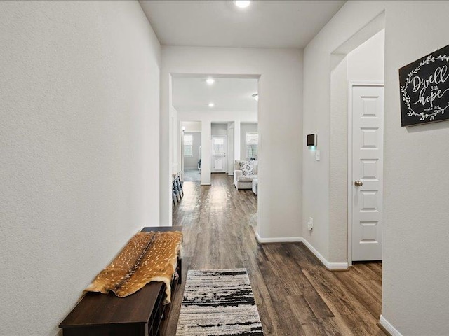hallway with baseboards, recessed lighting, and wood finished floors