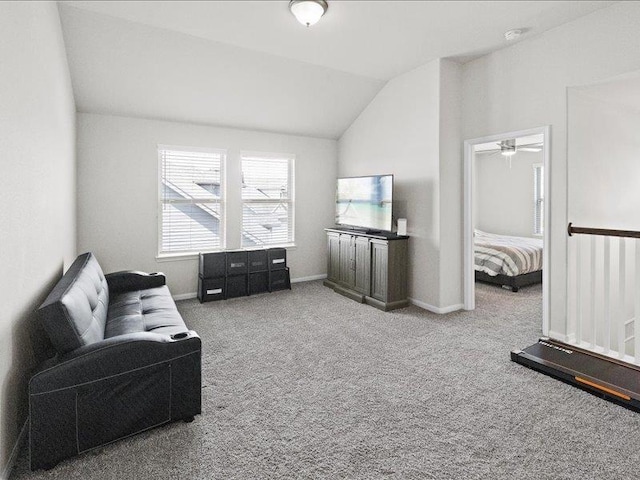 living area featuring carpet floors, baseboards, vaulted ceiling, and ceiling fan