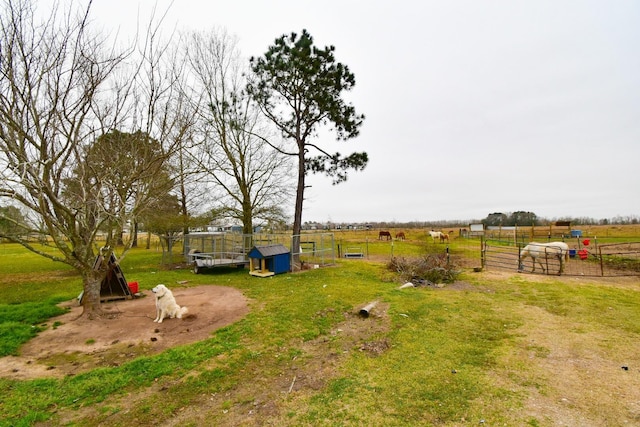 view of yard featuring a rural view and an outbuilding