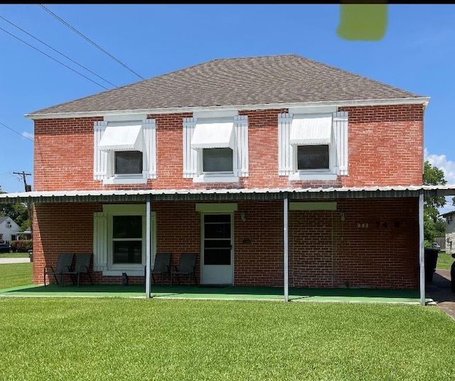 748 Queens Ct, Port Arthur, TX 77642 - view of front facade featuring a front yard, brick siding, and a shingled roof