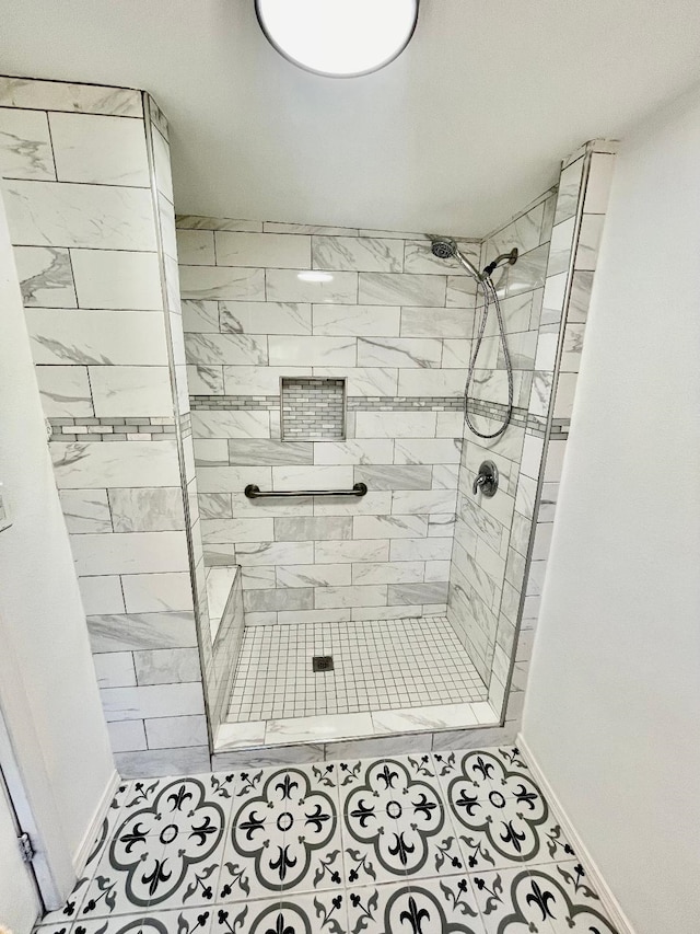 bathroom with tile patterned flooring and tiled shower