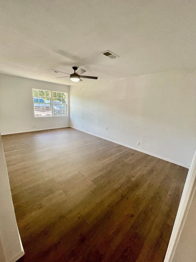 spare room with wood-type flooring and ceiling fan