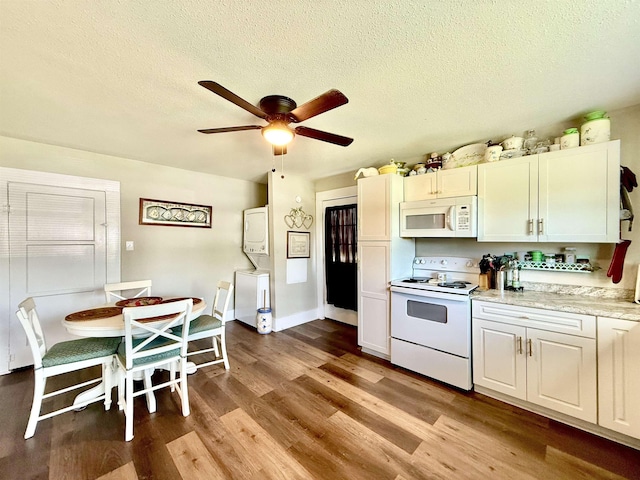 176 County Road 753, Buna, TX 77612 - kitchen with white appliances, wood finished floors, a ceiling fan, light countertops, and a textured ceiling