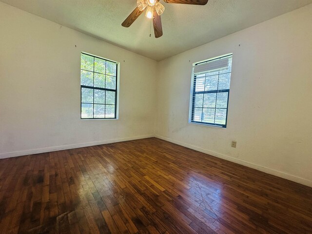 2922 Little Cypress Dr, Orange, TX 77632 - unfurnished room featuring dark wood-style floors, baseboards, and ceiling fan